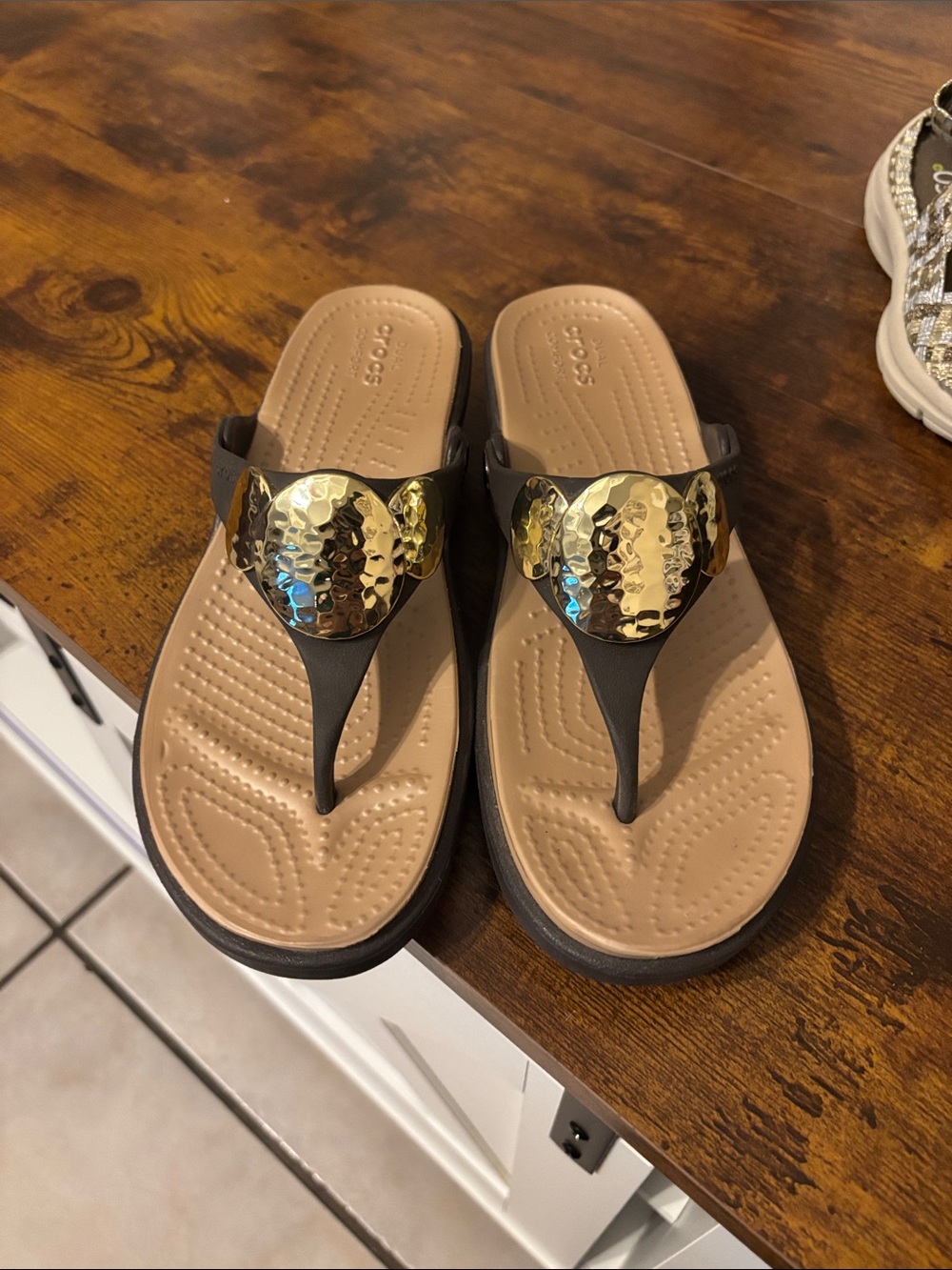 CROCS Women’s Brown Strappy Thong flip flop with Gold Hammered Disc Accent